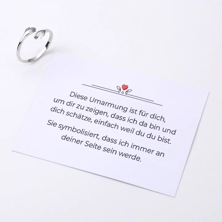 Umarmungsring mit liebevoller Notiz auf der Karte